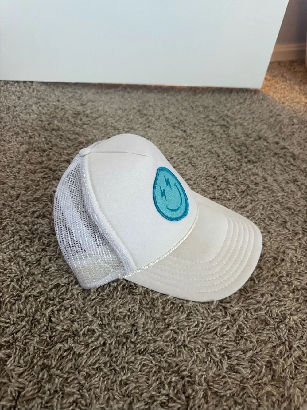 White Trucker Hat with Teal Smiley Patch